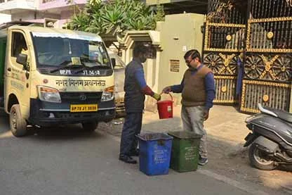 helper is collecting the solid waste