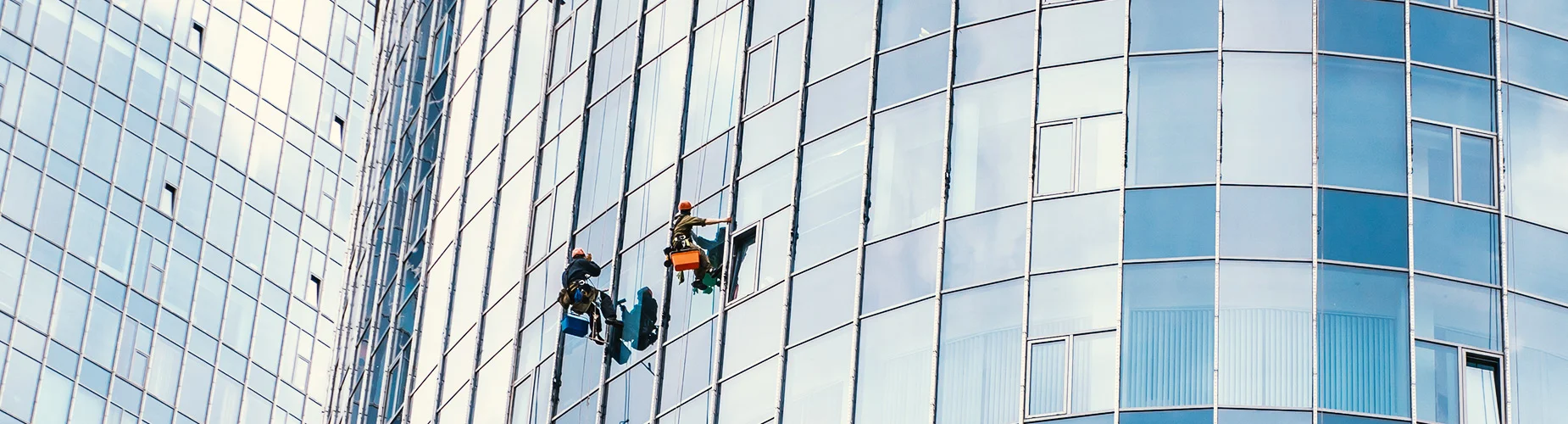 men cleaning glass of a building