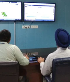 men sitting inside operation command centre