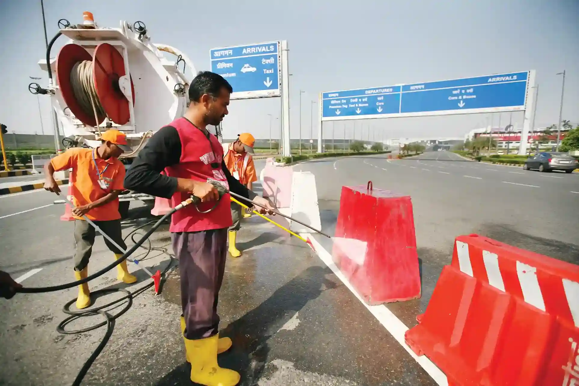 men washing the road divider